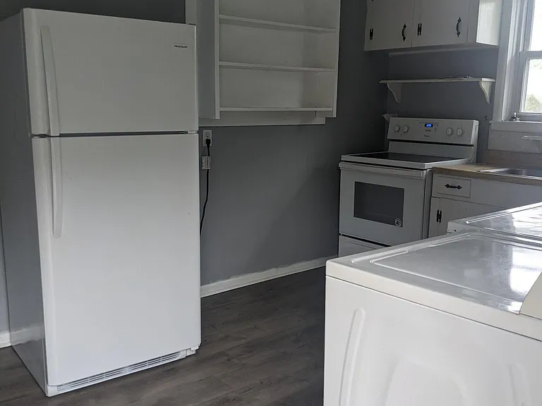 Kitchen with new refrigerator and over and flooring