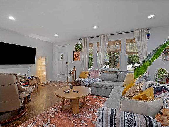 Living room view from Kitchen looking at the entrance door.