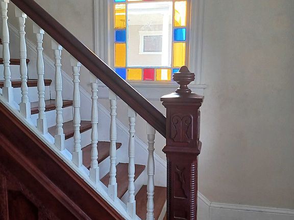 stairway with stained glass window