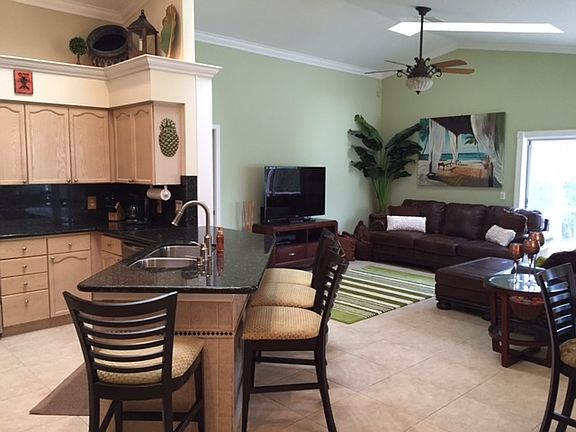 Kitchen and Den
						:
						Open den with sliding glass doors on two sides, sky lights