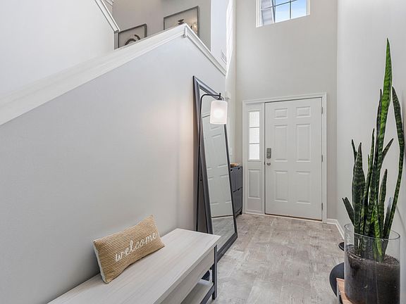 Foyer with transom windows and high ceilngs.