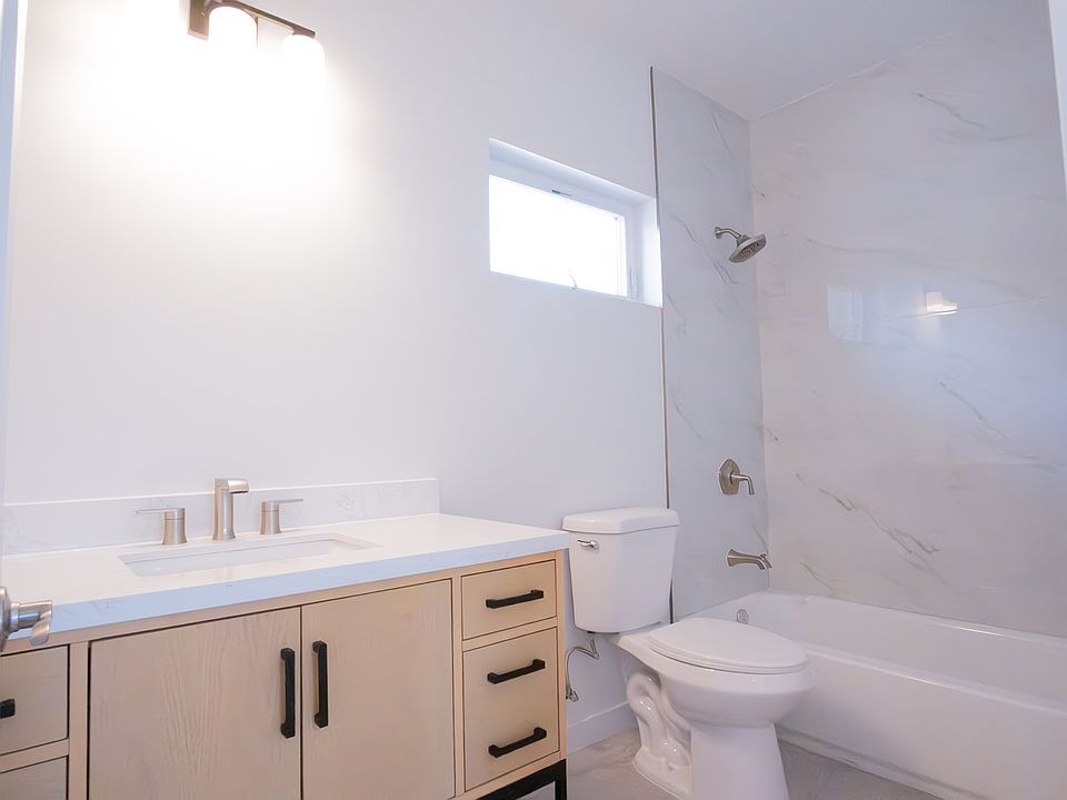 First floor Bathroom 1 vanity, toilet, shower, and windo