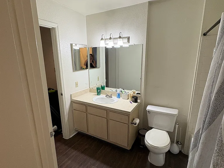 bathroom from bedroom 

bathroom entrances: to the left on the apartment entrance and from the bedroom