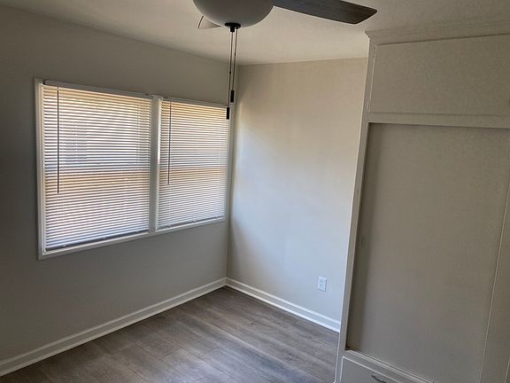 Bedroom with new wood flooring and ceiling fan