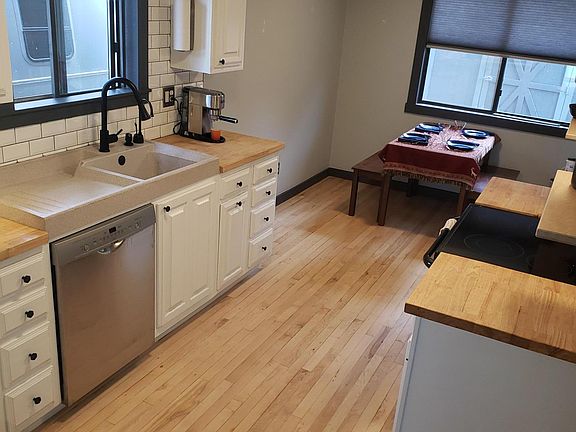 New kitchen, butcher block counters, European Corian sink unit.
