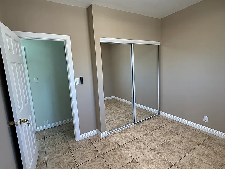 Bedroom with new window, fresh paint, new sliding mirror closet doors