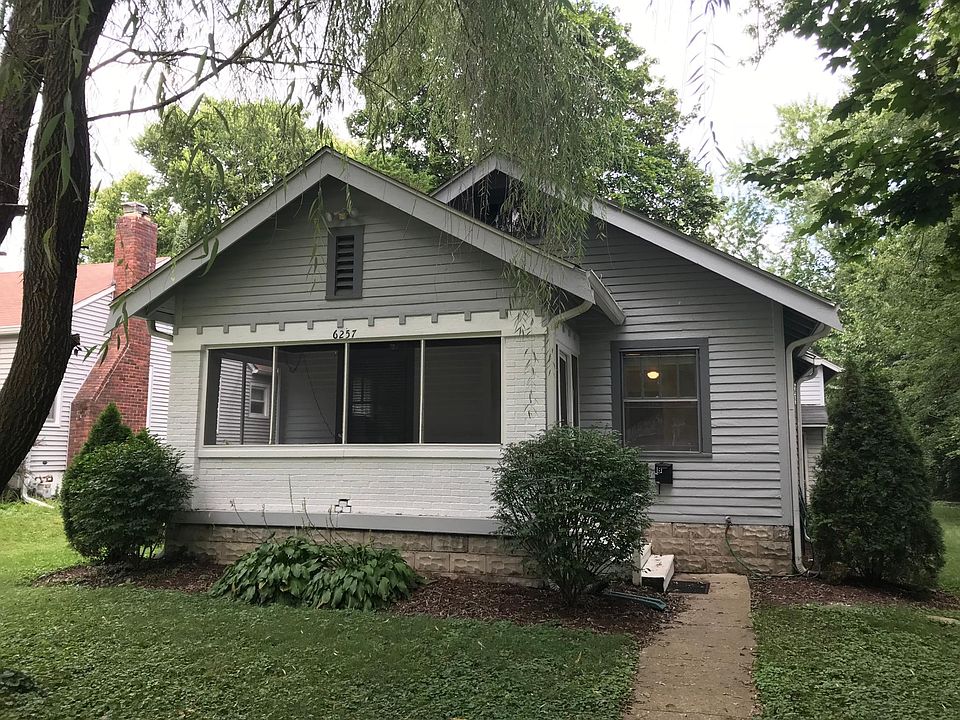 Front of house with large screened in porch.