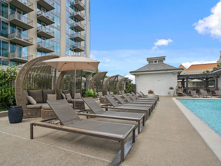 Cabanas and curated lounge seating define a refined poolside space designed for lingering comfort and laid-back luxury