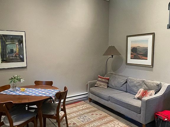 Living room space - showed with current tenants furniture for reference (space is rented unfurnished)