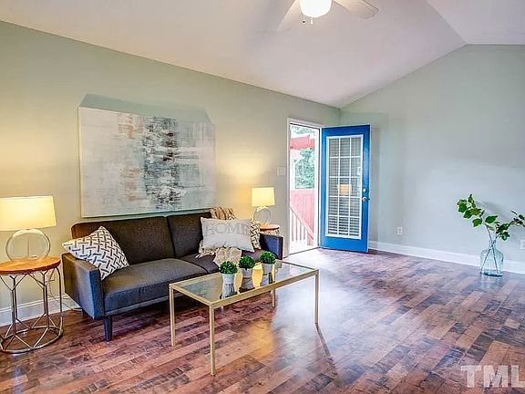 Another view of the living room, showing open door to the side porch