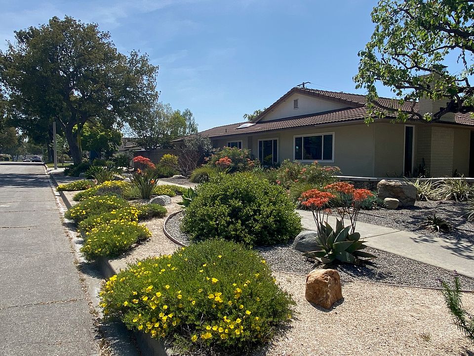 Beautifully landscaped corner lot attracts hummingbirds and butterflies.