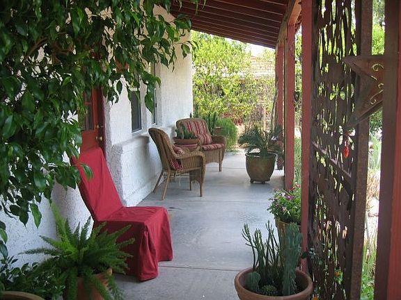 Cozy Front Porch with Artistic Sun Screens