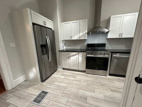 Fully renovated kitchen with granite countertops and all-new stainless steel appliances