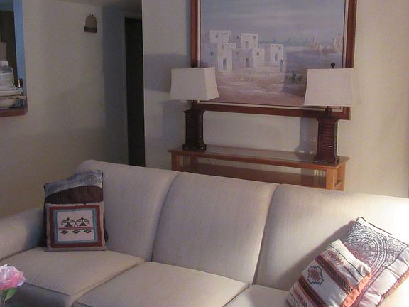 The "open concept" living area is well-appointed with ample lighting and attractive art work.