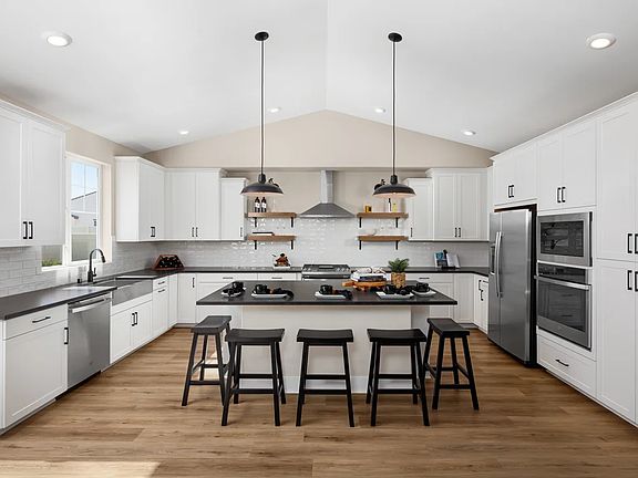 Kitchen with vaulted ceiling and pendant lighting