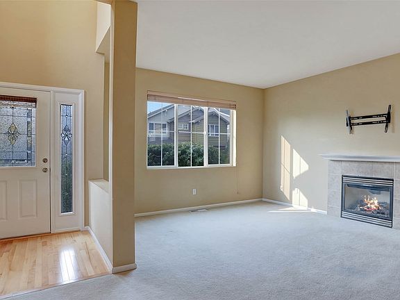 A half wall provides the perfect amount of separation between the entry and bright living room.>