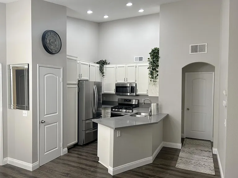 Renovated Kitchen includes quartz countertops, brand new garbage disposal, dishwasher, large fridge, microwave, gas top stove plus oven, and lots of storage space.