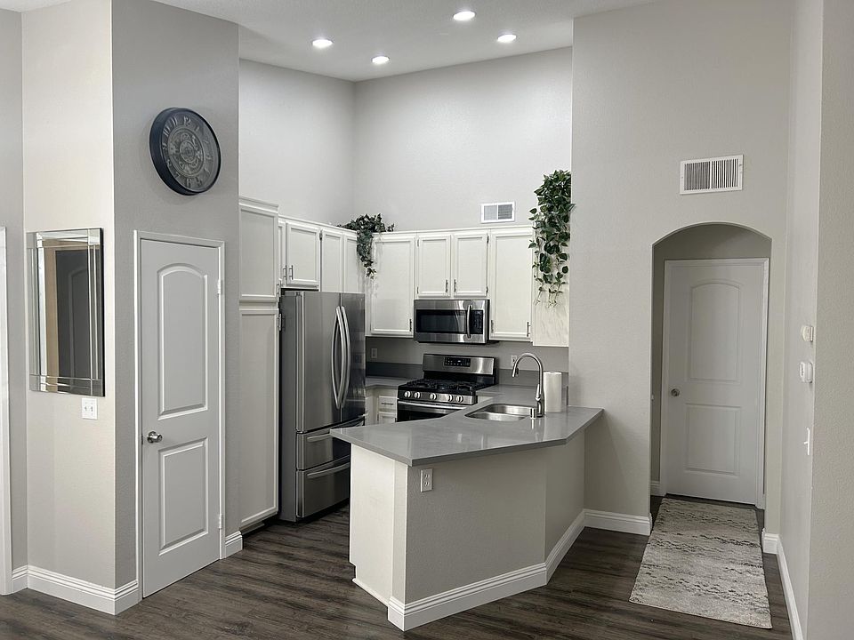 Renovated Kitchen includes quartz countertops, brand new garbage disposal, dishwasher, large fridge, microwave, gas top stove plus oven, and lots of storage space.