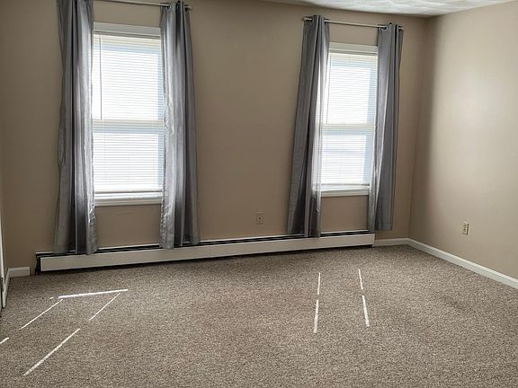 Bright and Sunny Family Room shown here with curtains and the blinds.