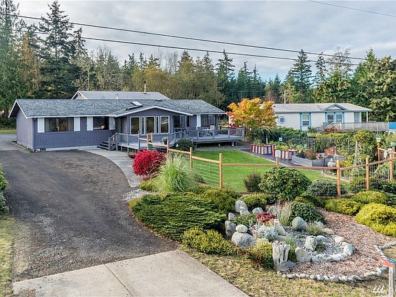Perched atop a rise this lovely home is perfectly situated to receive ample sunlight and allow for maximum water, mountain and island views from the deck or sunroom.