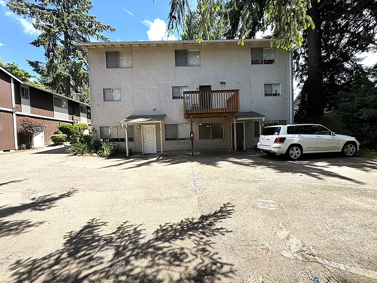 West side of building with adjacent parking.