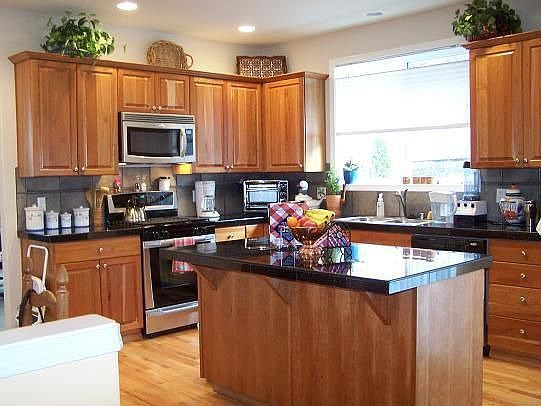 Cherry cabineted kitchen w/mystic granite counters