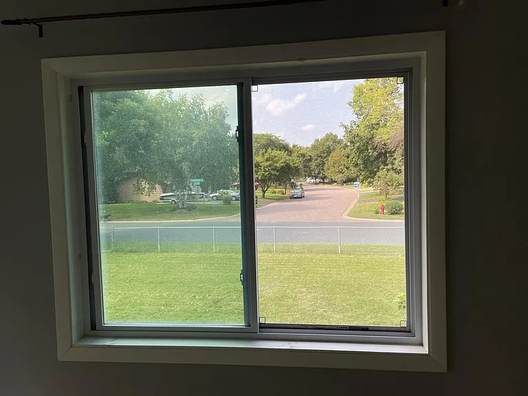 The master bedroom boasts an unobstructed view of the neighborhood down the street.