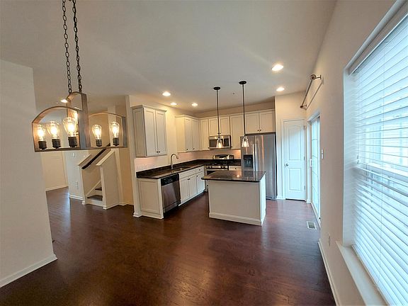 Kitchen with exit to a patio & grill