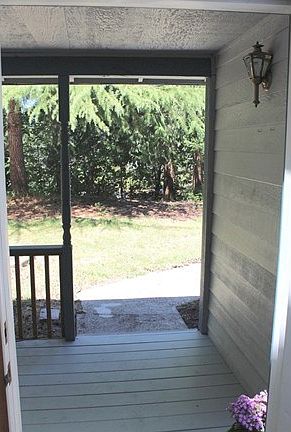 Looking out the front door to porch and yard.