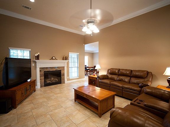Huge main living space with ceramic tile, recessed lighting, and fireplace.