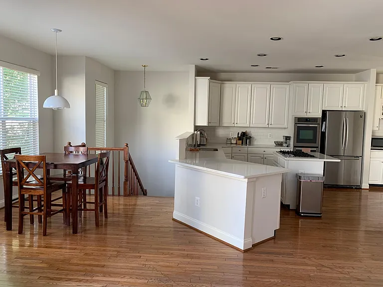 Open kitchen (with quartz countertops and stainless steel appliances)