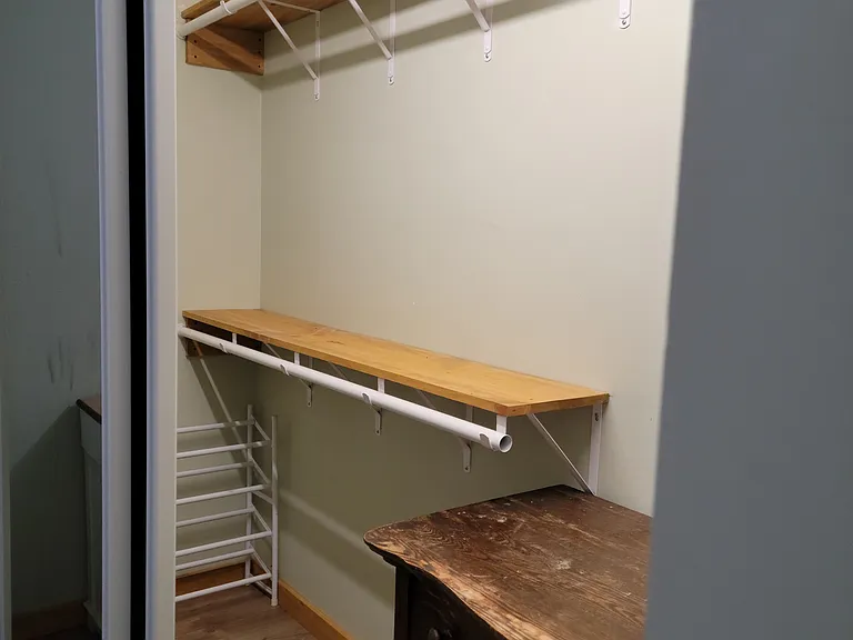 Main bedroom closet, dresser, shoe rack and hanging space