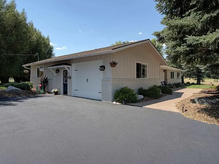 The large one car garage greets you after an easy drive down the fresh asphalt driveway and apron.