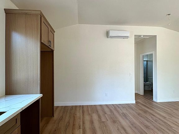 View of Unit 103 facing the rear of the building showcasing the vaulted ceilings and premium appointments