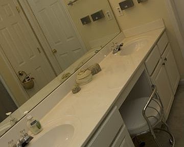 Generous master bath has double vanities and leads to a walk-in closet