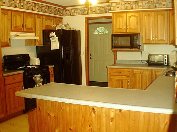 Oak kitchen with an abundance of cabinets plus pull out pantry and gas range.