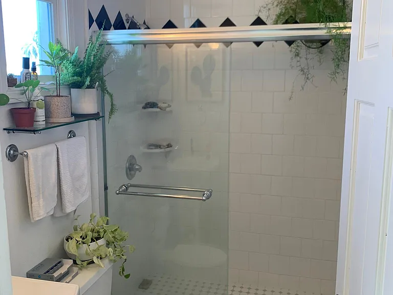 Smaller bathroom with 5 ft x 3 ft shower stall.