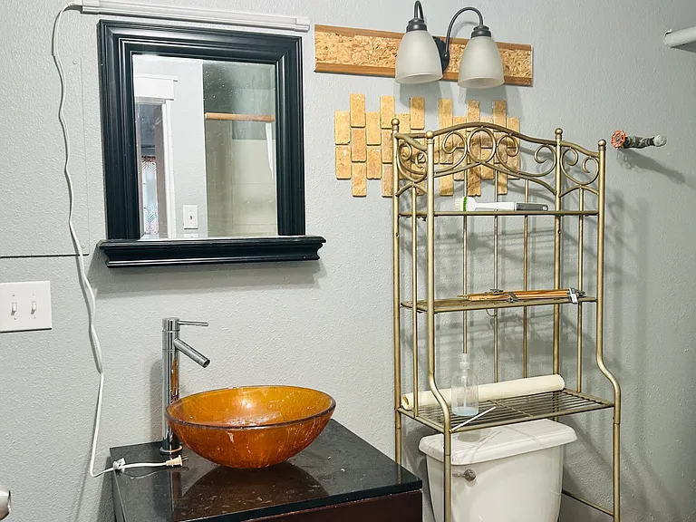 Fresh painted bathroom walls with glass sink.