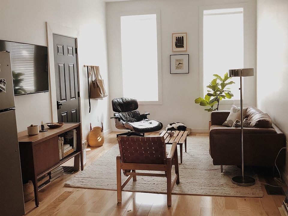 Living room with prehung TV mount and two oversized windows looking over Locust St.