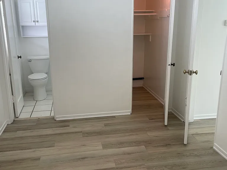View of bathroom and closet from bedroom.