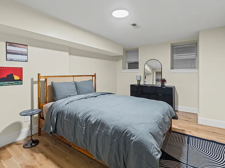 Cozy bedroom with closet and dresser.