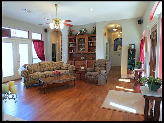 Built-in hutch with glass door and shelves to display your special treasures. Glass French doors open to backyard deck. Transom windows across the top allow for alot of natural light.  Hallway to 3 bedrooms with lit art niche.