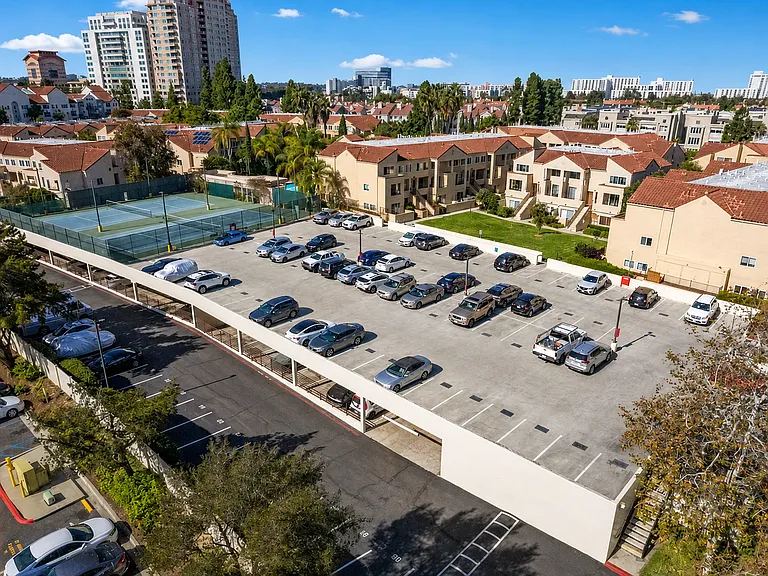 Enjoy two adjacent covered parking spaces here! The unit itself is on the right side of the lawn.