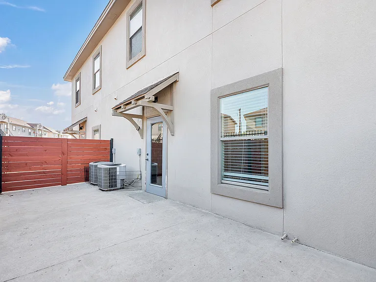 Small patio with a fence and door, located at Merida Vista Apartments in Laredo, Texas