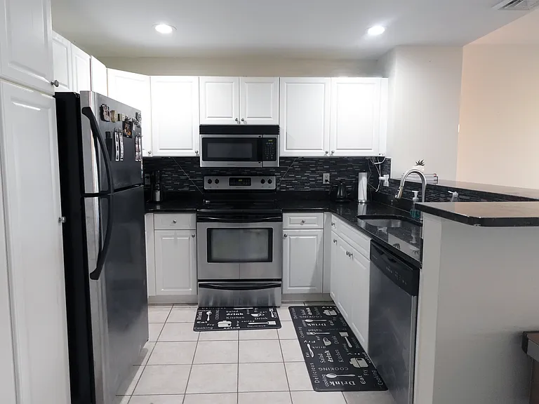 Open concept kitchen with stainless steel appliances
