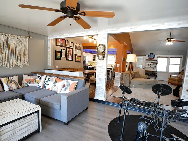 Sunroom open to main area. Has panoramic lake views, double french doors out to balcony, and dimmable lighting. (Drum set not included.) Inquire about fully furnished option.