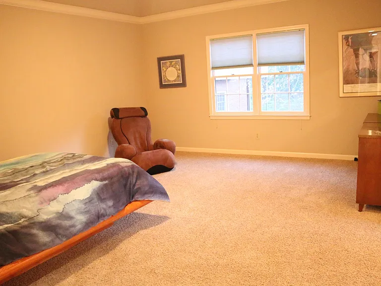 Large master bedroom adjacent to upstairs laundry room.