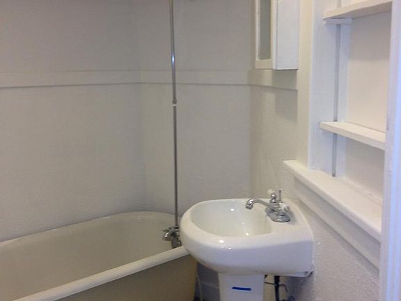 Quaint claw foot tub with shower.