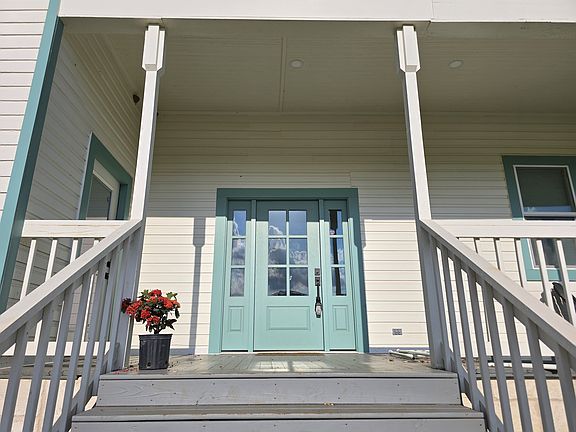 There are two doors on the front porch - one to the living area, one to bedroom 2.