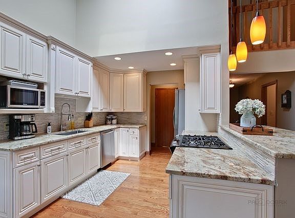 Bright and Airy Updated Kitchen with Granite Counters and Stainless Steel Appliances